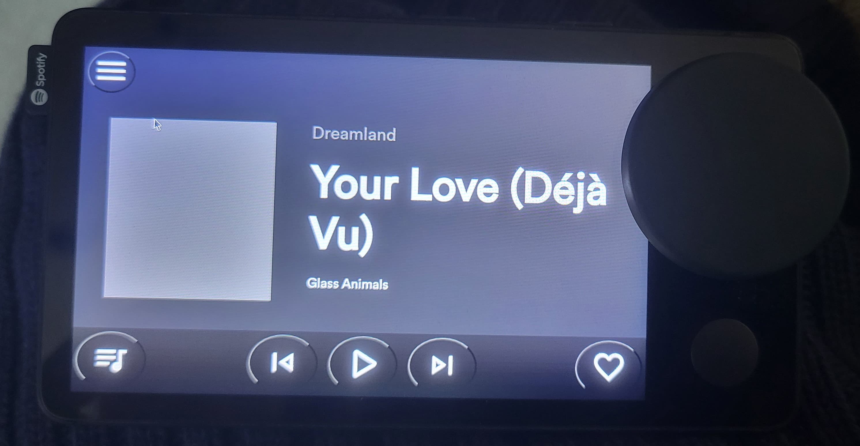 Revibe device displaying music control interface and current song information